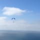 two parasailers are flying over the ocean